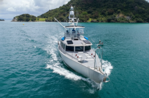 a grey FPB 64 in NZ with green water and a green island visible in the back ground