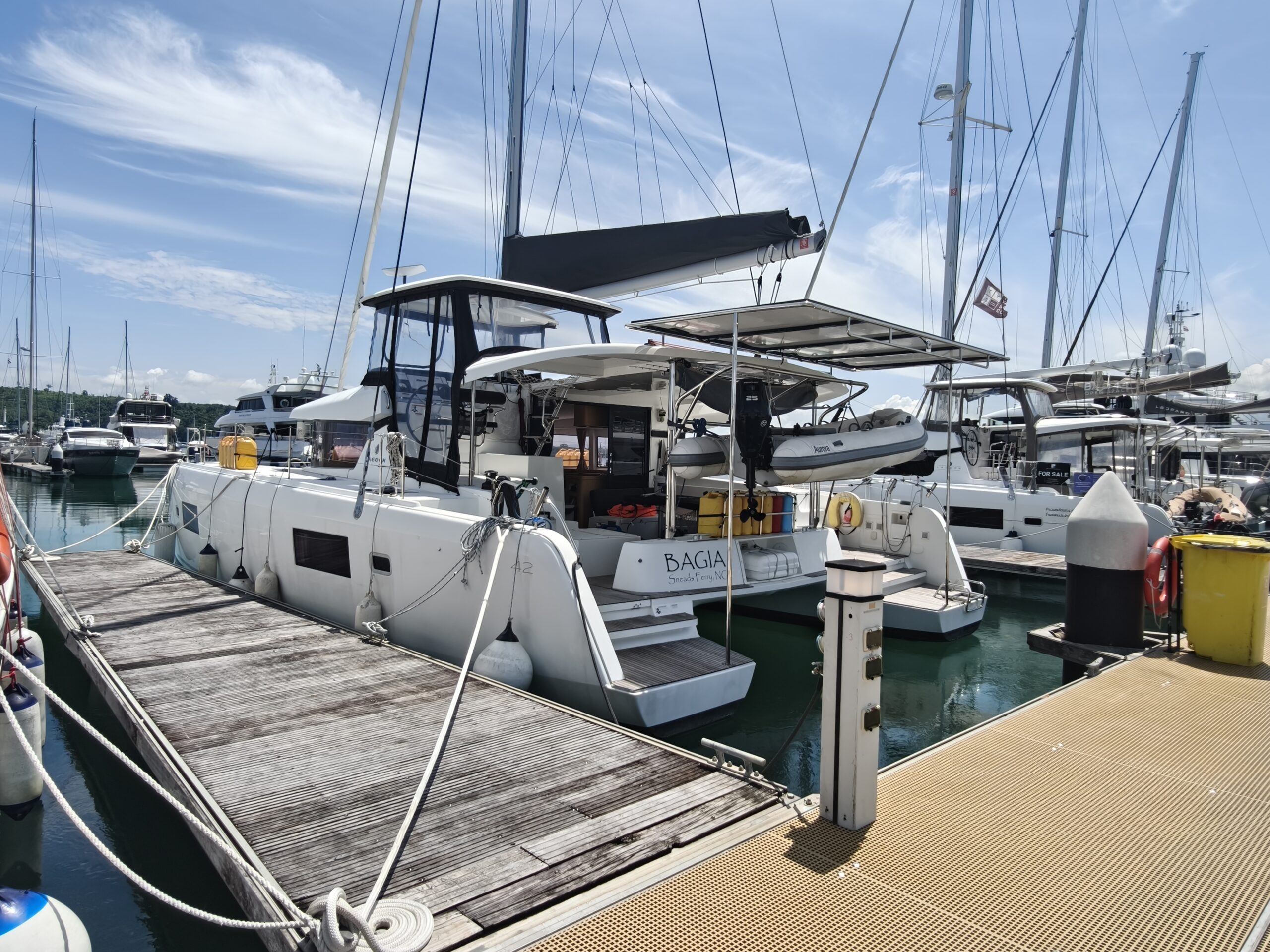 White Lagoon 420 in a wooden berth in a marina with blue sky after a yacht delivery