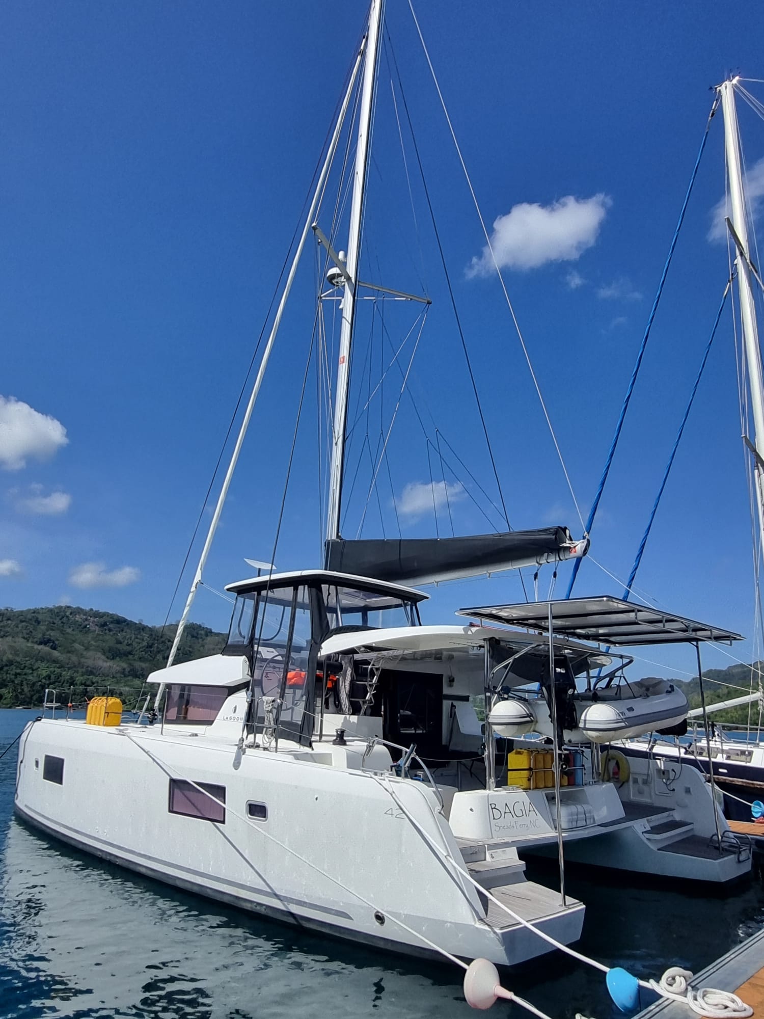 Leopard 44 with blue sky and white hull on a yacht delivery